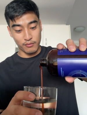 Man pouring juvia into a glass of water
