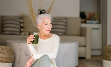 Lady relaxing with a green juice in her hand