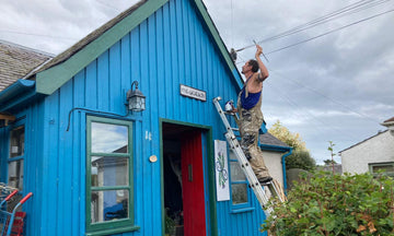 Dee on a ladder painting