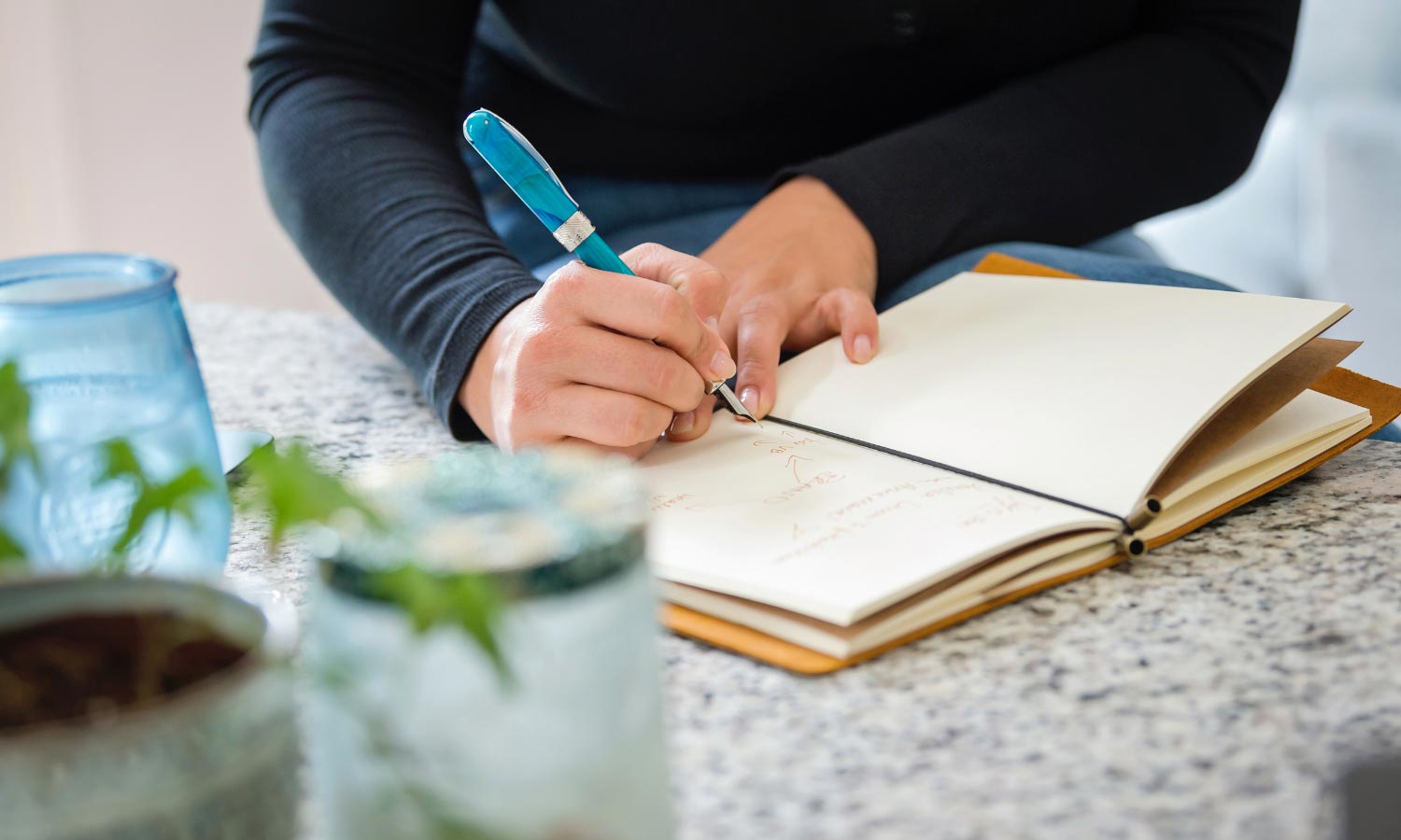 Person writing in their journal