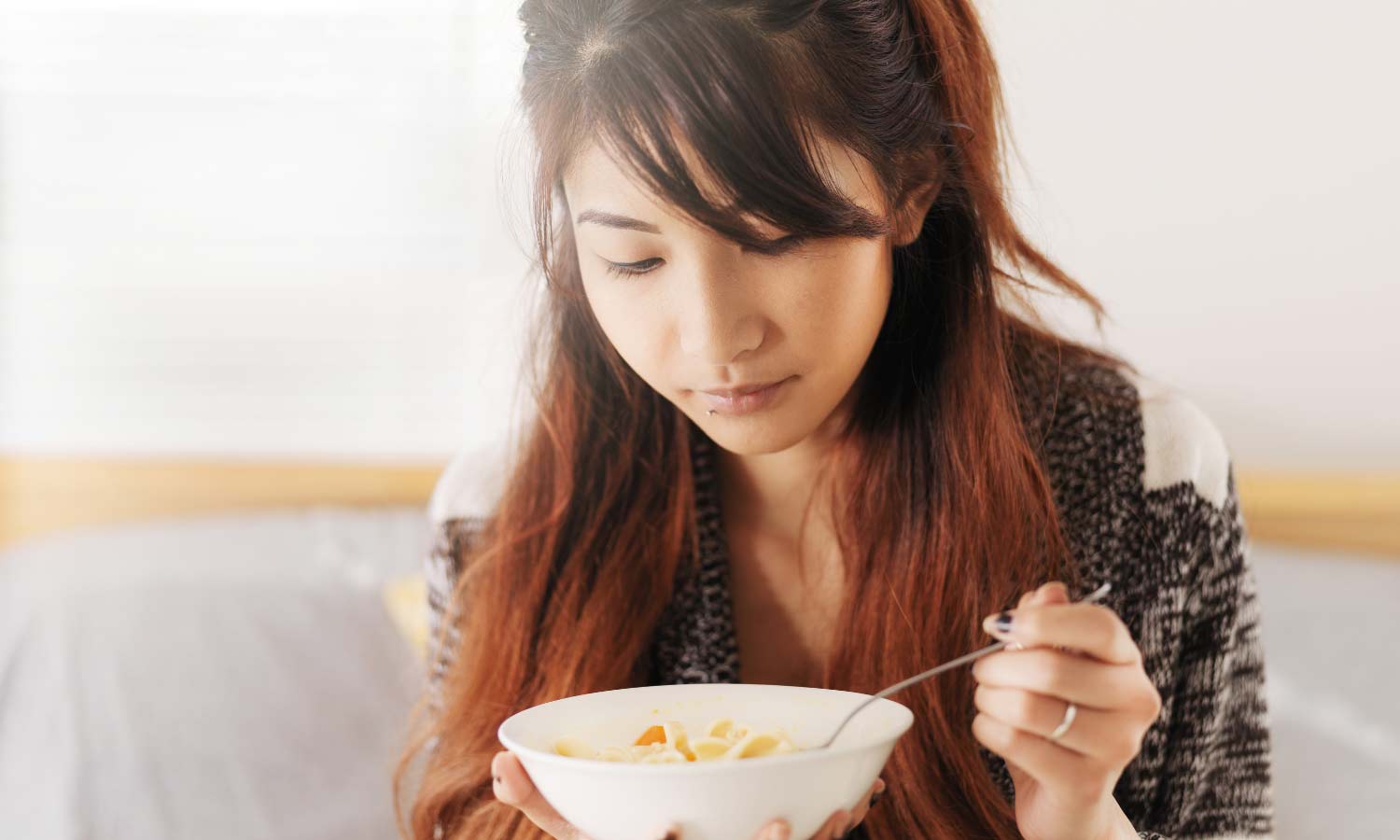 Lady eating a bowl of food