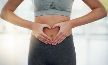 Women with her hands in a heart shape in front of her tummy
