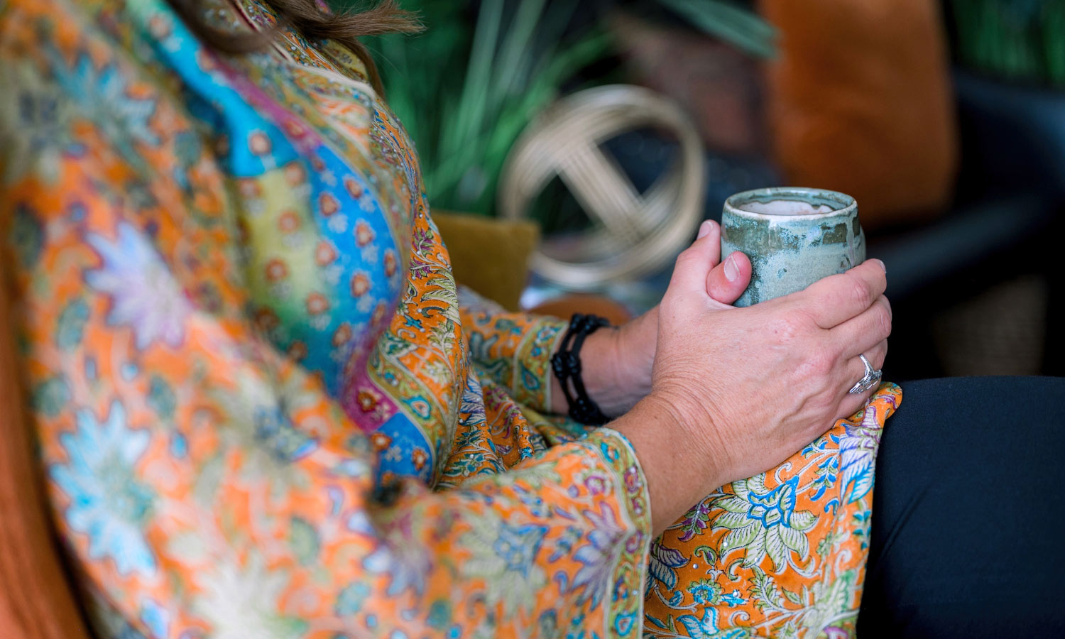 Lady sitting with a hot drink in a mug