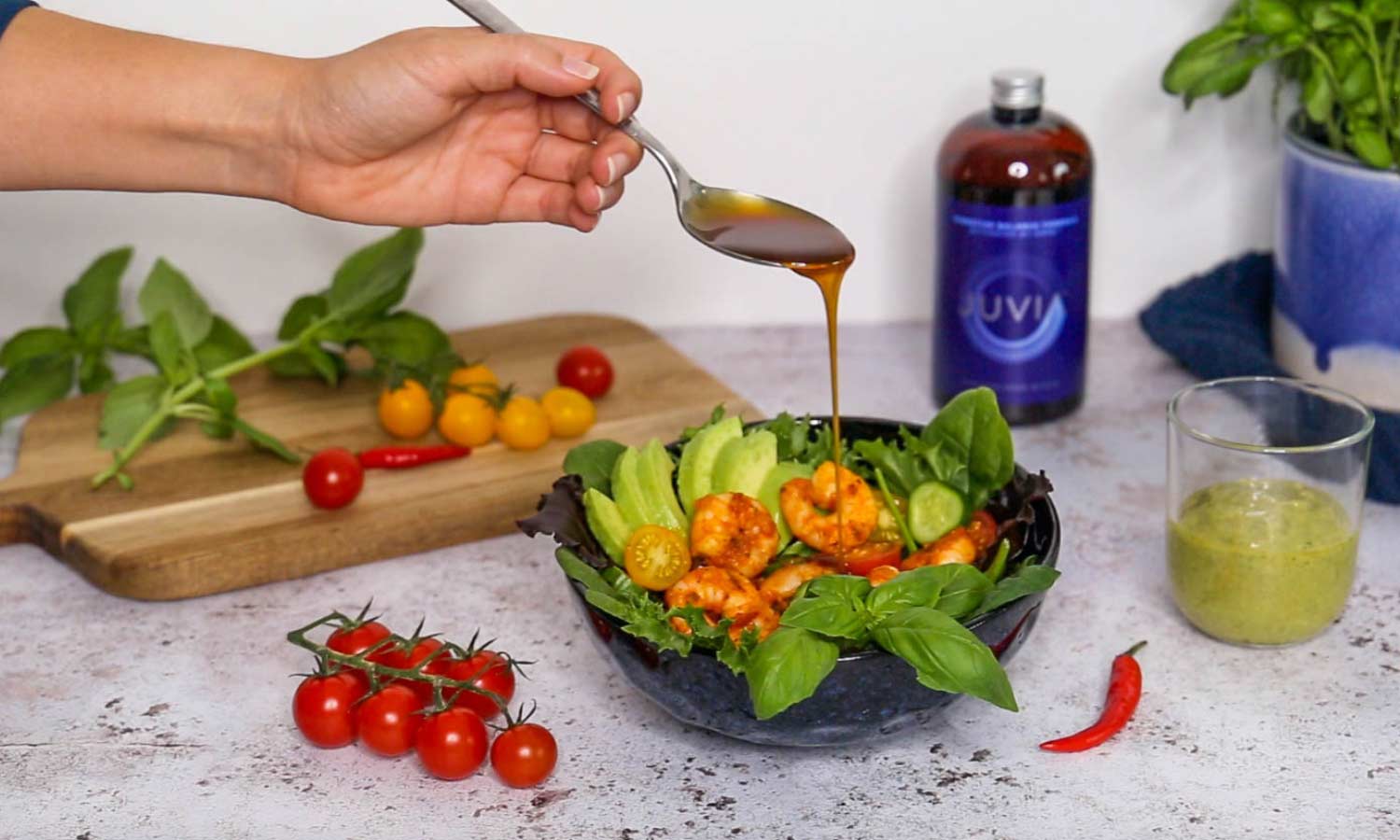 Pouring JUVIA onto prawn salad dish