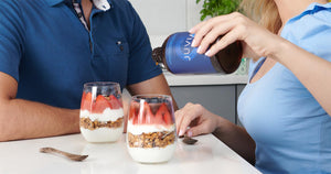 A couple puring JUVIA onto their yoghurt